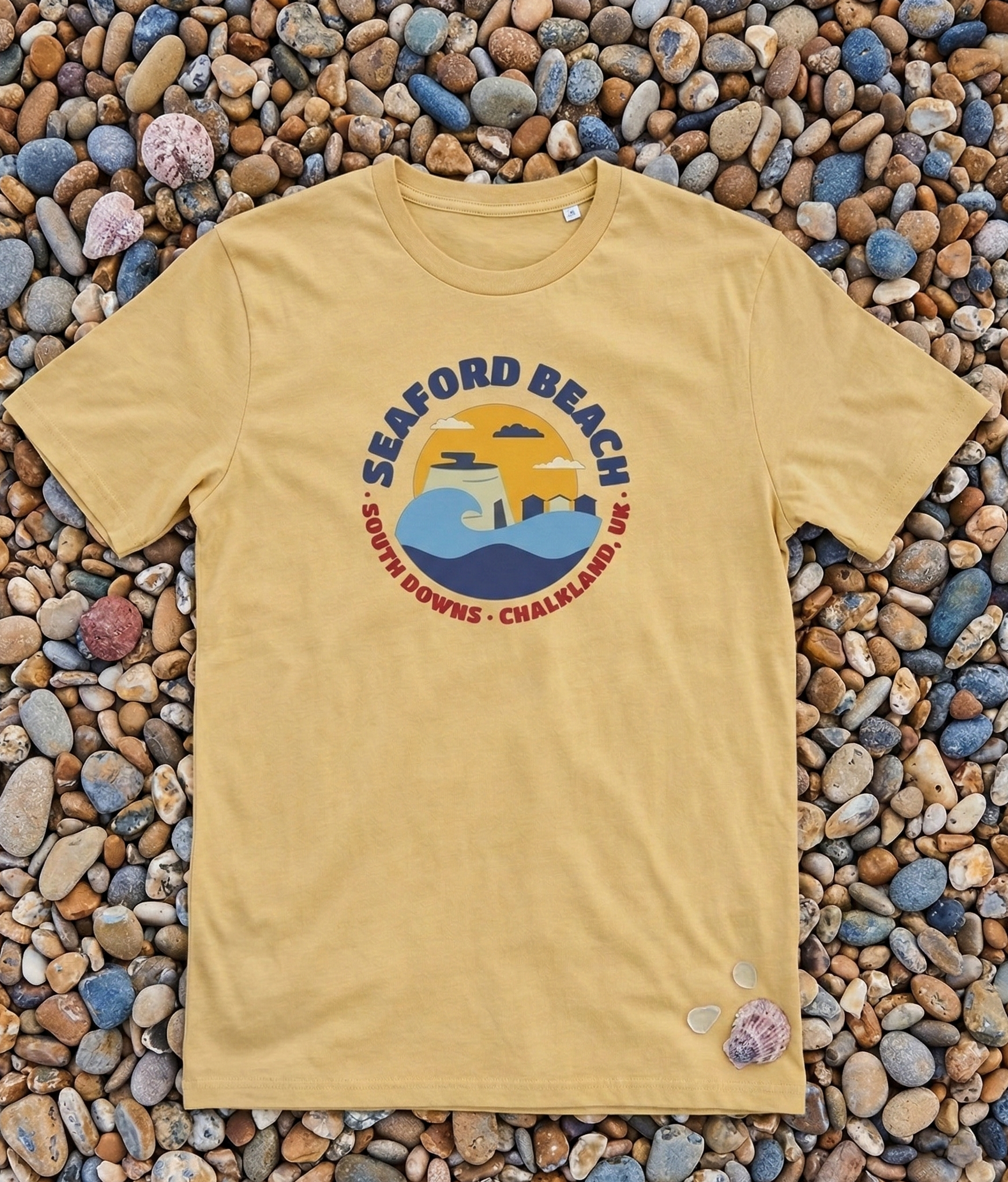 Yellow t-shirt with a beach graphic on pebbles